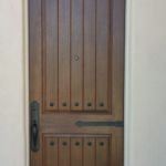Rustic door w/ iron decor, stained medium walnut, Emtek greeley handle set, iron decor includes hinge straps and clavos.