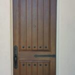Rustic door w/ iron decor, stained medium walnut, Emtek greeley handle set, iron decor includes hinge straps and clavos.