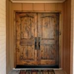 Knotty alder door, Emtek full length rectangular handle set, stained custom finish.