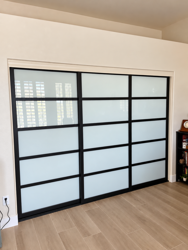 Modern black-framed frosted glass sliding closet doors