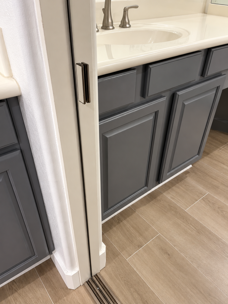 Close-up of sliding mirrored closet door track and frame