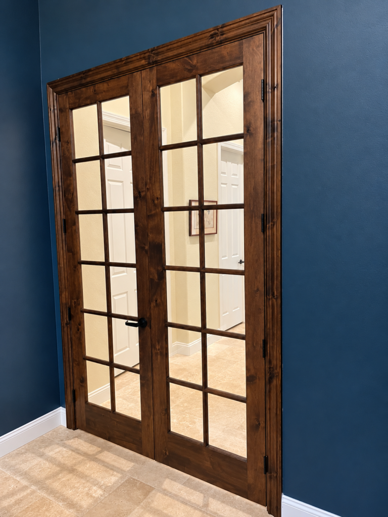Interior knotty alder French double doors with natural wood finish