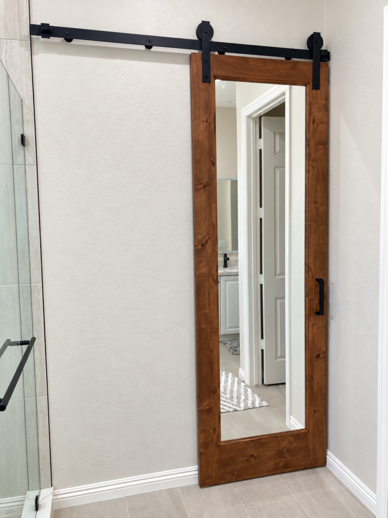 Interior wood barn door with black sliding track hardware